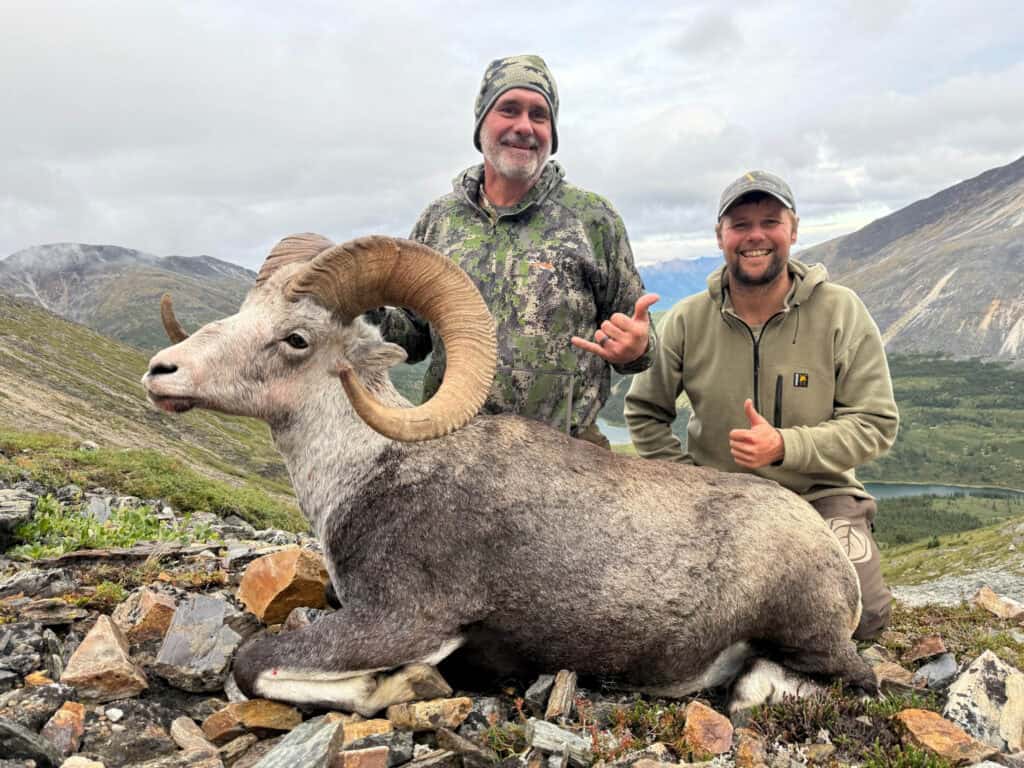 Hunting with guides in scenic wilderness for big game.